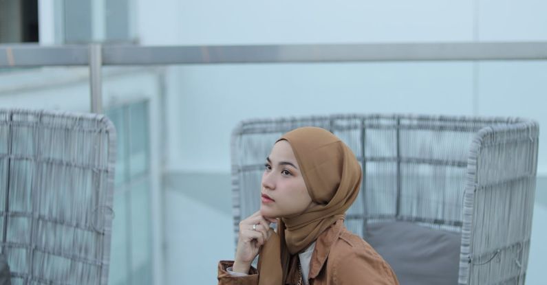 Outdoor Space - Hijabi Woman Sitting on Chair in Roof Garden