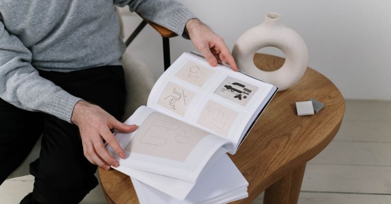 Furniture Designs - Person in Gray Sweater Holding a Book