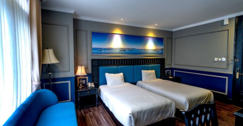 Sofa Beds - Hotel Room with Blue Furniture and White Bed Linen