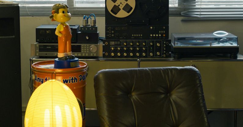 Vintage Items - A living room with a lamp, a chair, and a record player