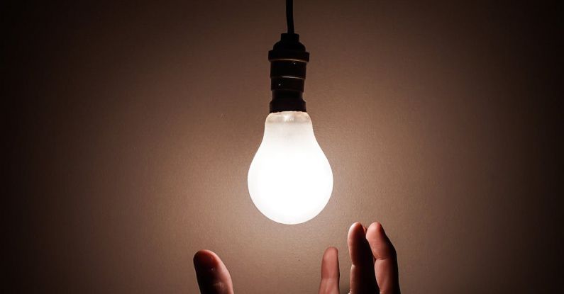 Energy-Efficient Lighting - Person Holding White Light Bulb