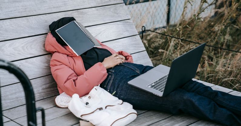 Garden Projects - Unrecognizable woman with laptop resting on bench in park