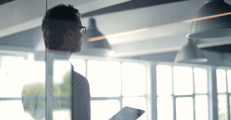 Smart Lighting - Formal man with tablet giving presentation in office