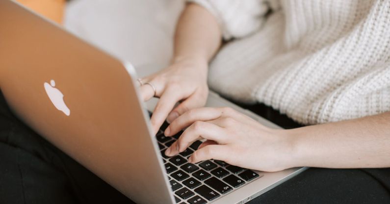 Smart Sensors - Crop woman typing on laptop on bed