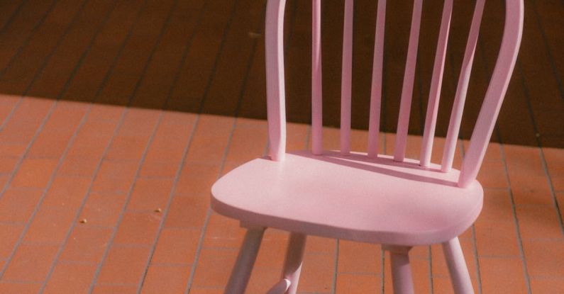 Upcycled Furniture - A pink chair sitting on a brick patio