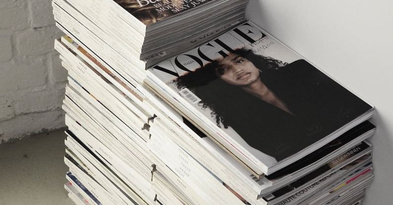 Smart Locks - High angle many fashion magazines stacked on floor against white brick wall in studio